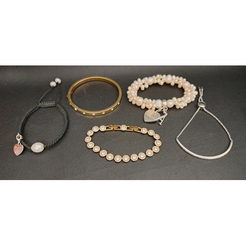 SELECTION OF FASHION JEWELLERY
comprising a Thomas Sabo Charm Club pearl cluster bracelet with two charms, a Michael Kors slider bracelet, a Swarovski crystal bracelet, a Kate Spade crystal set bangle, and a Thomas Sabo woven bracelet set with a pearl