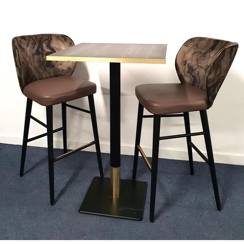 BLACK ASH EFFECT HIGH BISTRO TABLE AND TWO BAR STOOLS
the table with a square top and brass effect edge on a turned metal column with brass collar and black metal weighted base, 114cm high, the top 70cm x 70cm; the high back stools with shaped backs and padded seats