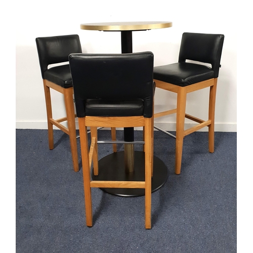 BLACK ASH EFFECT HIGH BISTRO TABLE AND THREE BAR STOOLS
the table with a circular top and brass effect edge on turned metal column with brass collar and black metal weighted base, 114cm high, the top 60cm diameter; the bar stools with vinyl padded backs and seats