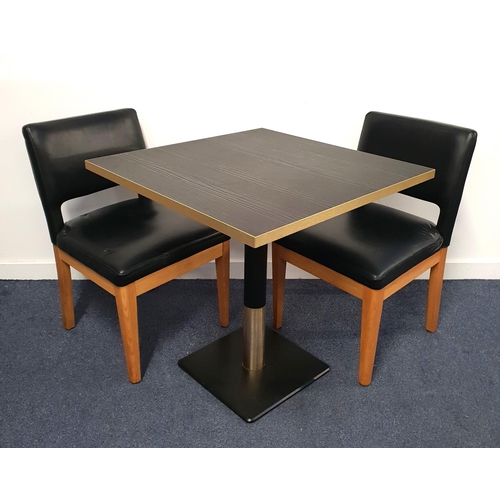BLACK ASH EFFECT TABLE AND TWO CHAIRS
the table with a square top and brass effect edge on turned metal column with brass collar and black metal weighted base, 76cm high, the top 75cm x 75cm; the chairs with vinyl padded backs and seats