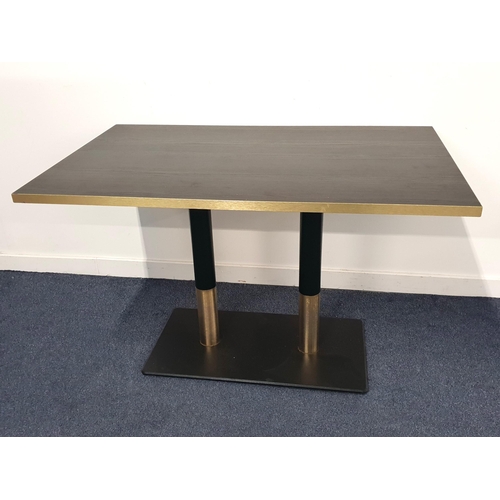 BLACK ASH EFFECT RECTANGULAR TOPPED TABLE 
with brass effect edge on turned metal columns with brass collar and black metal weighted base, 76cm high, the top 120cm x 75cm