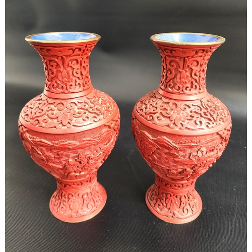 PAIR OF CHINESE CINNIBAR VASES
with ornate decoration, the bases later drilled for lamp wiring, 20.5cm high (2)