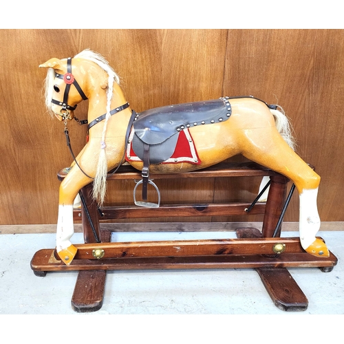 FURZEDOWN ROCKING HORSE
with a leather bridle, saddle and stirrups, on a trestle base, 82.5cm x 122cm