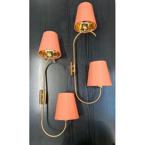 TWO PAIRS OF BRASS WALL LIGHTS
each with rotating shaped arm with conical coral coloured shades, 74cm high (2)