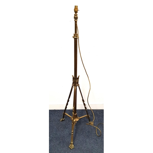 376 - EDWARDIAN BRASS STANDARD LAMP
with a telescopic column on a triform base with lion paw feet, 131cm h... 