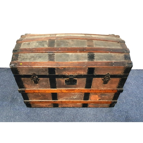 VINTAGE DOMED TOP TRAVEL TRUNK
with a banded body and metal corners, 56.5cm x 83.5cm x 47.5cm
