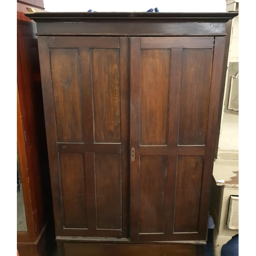 377 - OAK WARDROBE
with a moulded cornice above two panelled doors opening to reveal hanging rails, the ba... 