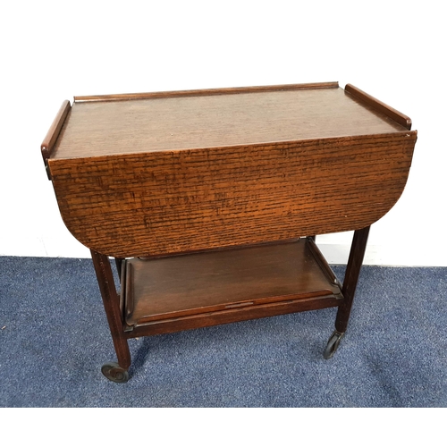 1950s OAK TEA TROLLEY
with a rectangular top with shaped drop flaps, the undertier with a removeable tray, on casters, 68cm high