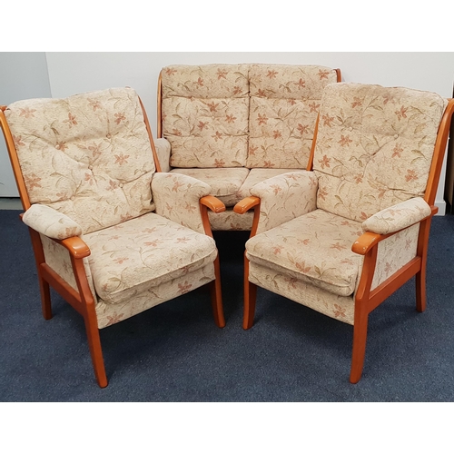 JOHNSON HOLLAND THREE PIECE SUITE
comprising a two seat sofa and two armchairs, each with stick backs and loose floral decorated back and seat cushions (3)