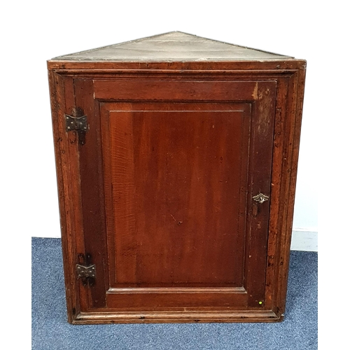 305 - GEORGIAN OAK CORNER CUPBOARD
with a panelled door opening to reveal a shelved interior, 90.5cm high