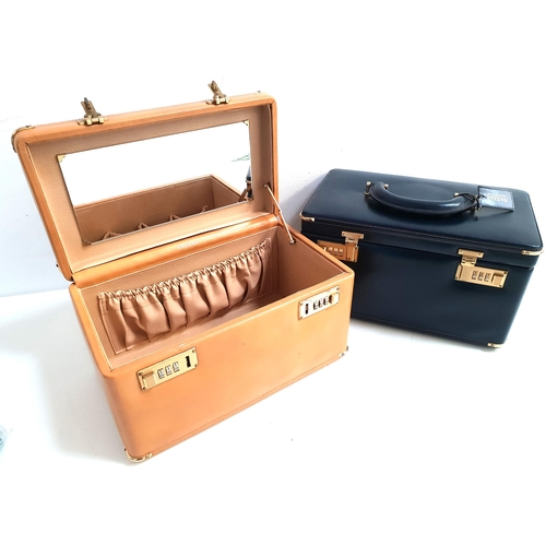 254 - TWO ITALIAN GAZZAZ VANITY CASES
one in navy blue, the other in tan, both with carry handles to the l... 