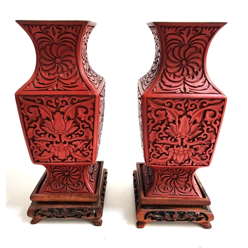 239 - PAIR OF CHINESE CINNIBAR VASES
with decorative floral decoration on square hardwood stands, 23cm hig... 