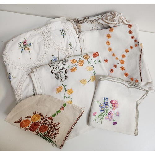 SELECTION OF VINTAGE NAPERY
including an embroidered tea cosy, table runner and six various table cloths of varying size and design