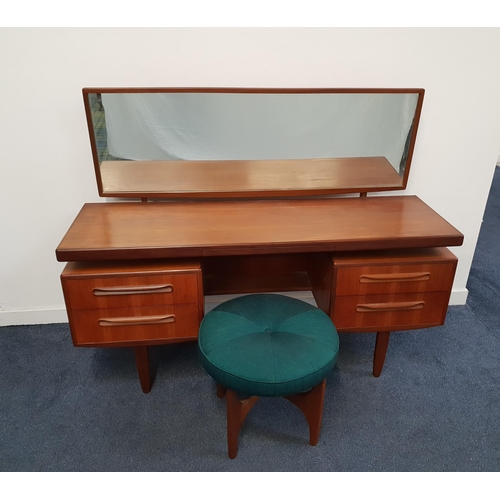 G PLAN TEAK DRESSING TABLE AND STOOL
the rectangular mirror back above an arrangement of five drawers, standing on tapering supports, 152cm wide, together with a G Plan Astro teak circular stool (2)