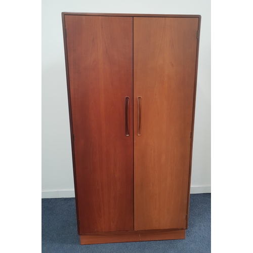 G PLAN TEAK WARDROBE
with two doors opening to reveal a hanging rail, shelves and drawers, standing on a plinth base, 175.5cm x 91.5cm x 58.5cm
