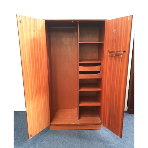 354 - G PLAN TEAK WARDROBE
with a pair of sliding fold back doors and a single door opening to reveal a ha... 