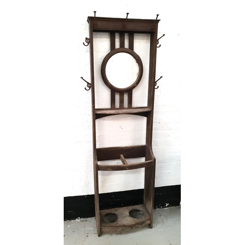 1930s OAK HALL STAND
with a central circular mirror and an arrangement of seven coat hooks above a pair of bow front stick recesses, 185.5cm x 54cm