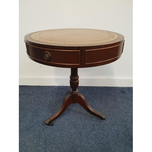 MAHOGANY DRUM TOP OCCASIONAL TABLE
with a tooled leather inset top above two frieze drawers, standing on a turned column with three reeded outswept supports with lion paw feet and casters, 56.5cm high