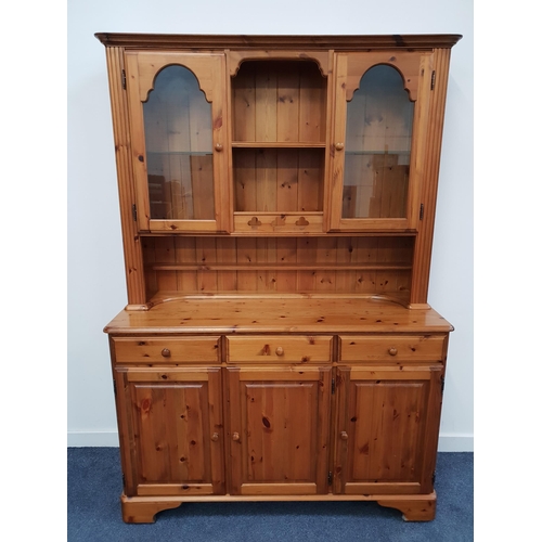 401 - DUCAL PINE DRESSER 
the upper section with a central recess with two shelves flanked by a pair of gl... 