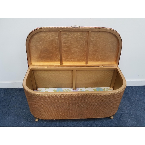 416 - D SHAPED WICKER OTTOMAN
with a padded lift up lid above a gold coloured body, standing on stout cabr... 