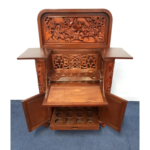 402 - CHINESE CARVED TEAK HOME BAR
with a D shaped lift up lid revealing a carved interior depicting warri... 