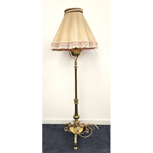 384 - 19th CENTURY BRASS OIL STANDARD LAMP
now converted to electricity, raised on three scroll supports w... 