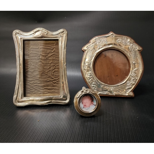 173 - GEORGE V SILVER PHOTOGRAPH FRAME
of serpentine form with bead and foliate decoration, with an easel ... 