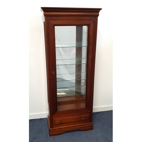 ERNEST MENARD ILLUMINATED CHERRY DISPLAY CABINET
with a moulded top above glass side panels and a glass door, the interior with a mirror back and glass shelves, with a drawer below, 168.5cm x 70cm x 35.5cm