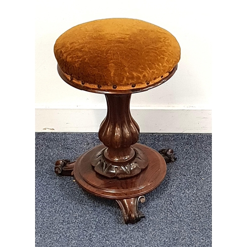 444 - MID VICTORIAN ROSEWOOD PIANO STOOL
with a circular padded adjustable seat on a shaped column and cir... 