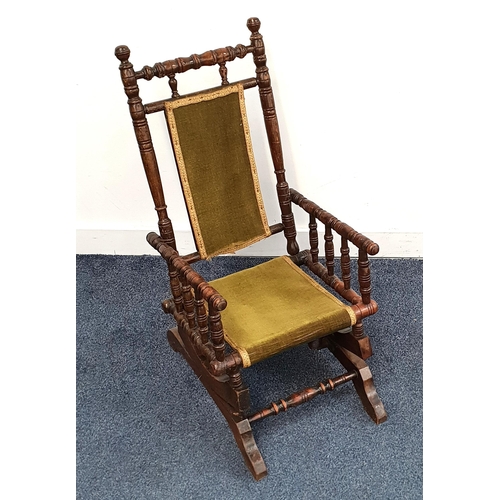 CHILD'S AMERICAN ROCKING CHAIR
with turned columns, green velvet panel back and seat
