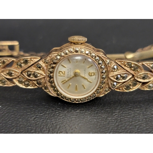 15 - LADIES MARCASITE SET EMCA INCABLOC NINE CARAT GOLD CASED WATCH 
the circular dial with Arabic 12 and... 