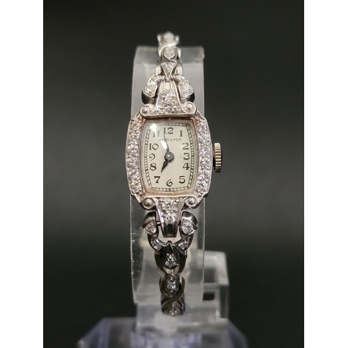 LADIES HAMILTON WATCH COMPANY DIAMOND SET COCKTAIL WATCH
in platinum case and on fourteen carat white gold bracelet, the case and strap all set with diamonds totalling approximately 1.2cts, with 17 jewels movement, the dial set with Arabic numerals