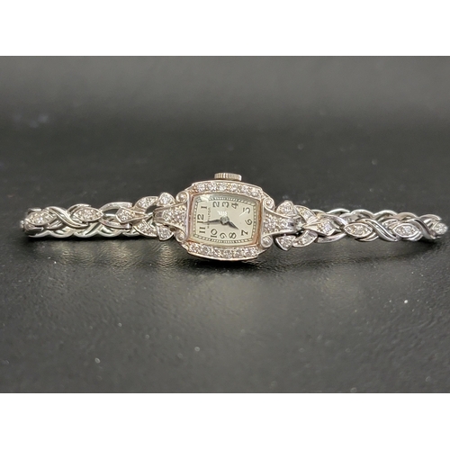26 - LADIES HAMILTON WATCH COMPANY DIAMOND SET COCKTAIL WATCH
in platinum case and on fourteen carat whit... 