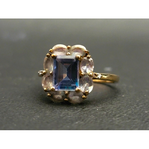 51 - MYSTIC TOPAZ CLUSTER RING
the central rectangular step cut topaz surrounded by eight lighter tone to... 