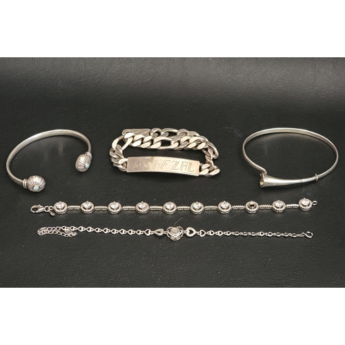 55 - SELECTION OF FIVE SILVER BANGLES AND BRACELETS
comprising a bangle with trumpet shaped flower detail... 