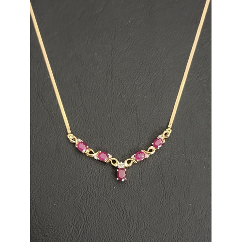 104 - RUBY AND DIAMOND NECKLACE
in nine carat gold, the front pendant section set with five oval cut rubie... 