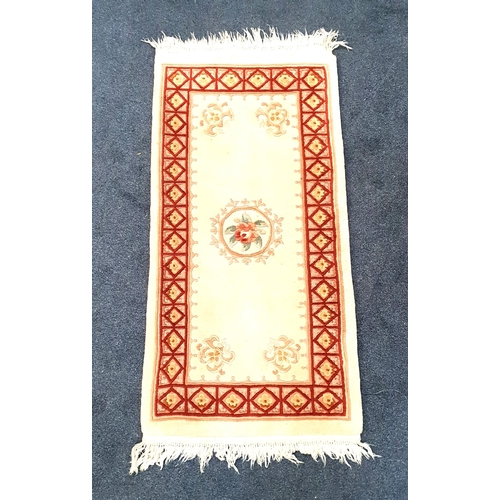 451 - CHINESE WASH HEARTH RUG
with a mushroom ground and central floral motif, encased by a red geometric ... 