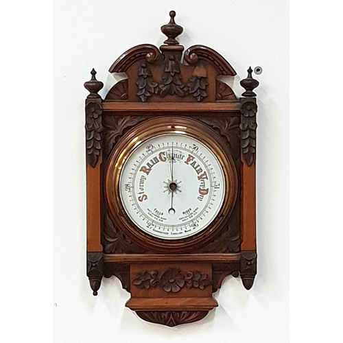 468 - WALNUT ANEROID BAROMETER
in a carved case with a circular dial, 49cm high