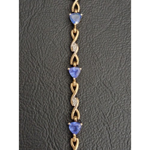 2 - TANZANITE AND DIAMOND SET BRACELET
the six trillion cut tanzanites separated by diamond set entwined... 