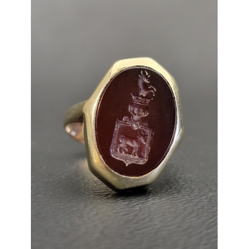 SEAL RING
the matrix with crest featuring two horned animals above and below a crowned armour helmet, on unmarked high carat gold shank, ring size N-O and approximately 7.4 grams