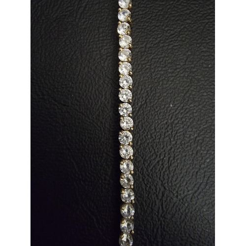 114 - CZ LINE BRACELET
in fourteen carat gold, approximately 19cm long and 12 grams