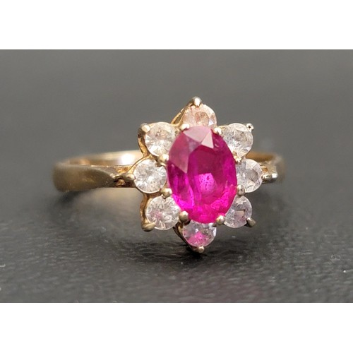 RUBY AND CLEAR GEM SET CLUSTER RING
the central oval cut ruby approximately 0.75cts in surround of eight clear gemstones, on nine carat gold shank, ring size N and approximately 2.3 grams