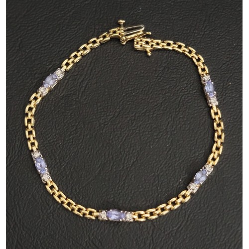 TANZANITE AND DIAMOND BRACELET
each of the five oval cut tanzanites with small diamonds to each side, the clusters separated by chain link sections, in fourteen carat gold,18cm long and approximately 6.2 grams