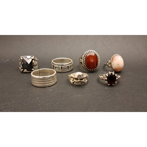 18 - GOOD SELECTION OF SEVEN SILVER RINGS
including an agate set statement ring with relief decorated sho... 