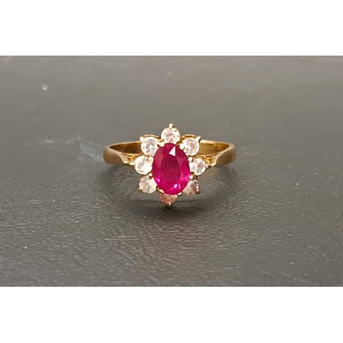 127 - RUBY AND CLEAR GEM SET CLUSTER RING
the central oval cut ruby approximately 0.75cts in surround of e... 