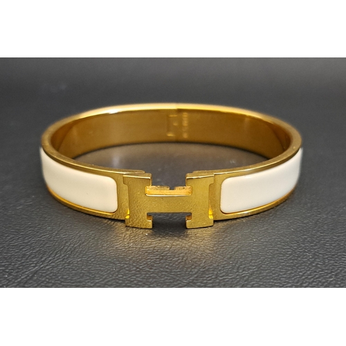 151 - HERMES CLIC H BRACELET
with off white enamel panels against gold plated hardware, with classic H cla... 