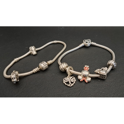 157 - TWO PANDORA MOMENTS SILVER CHARM BRACELETS
one with three charms and two clips and the other with tw... 