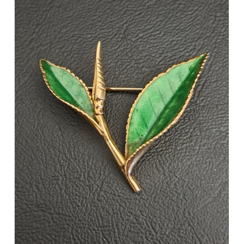 GREEN ENEAMEL DECORATED LEAF BROOCH
in fourteen carat gold, indistinctly signed, possibly 'NACo.', 4.3cm maximum width and approximately 7 grams