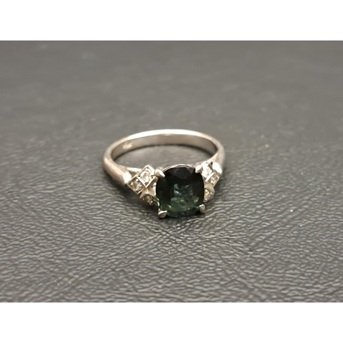 56 - GREEN TOPAZ AND DIAMOND SET RING
the central cushion cut topaz approximately 1.4cts, on eighteen car... 