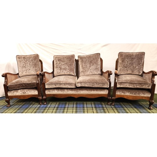 388 - EARLY 20th CENTURY OAK BERGERE SUITE
comprising a two seat sofa and two armchairs with shaped backs ... 